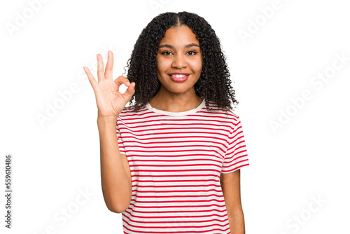 Young african american woman with curly hair cut out isolated cheerful and confident showing ok gesture.