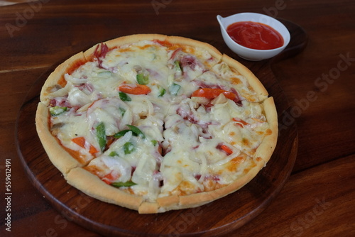 Pizza on a wooden plate