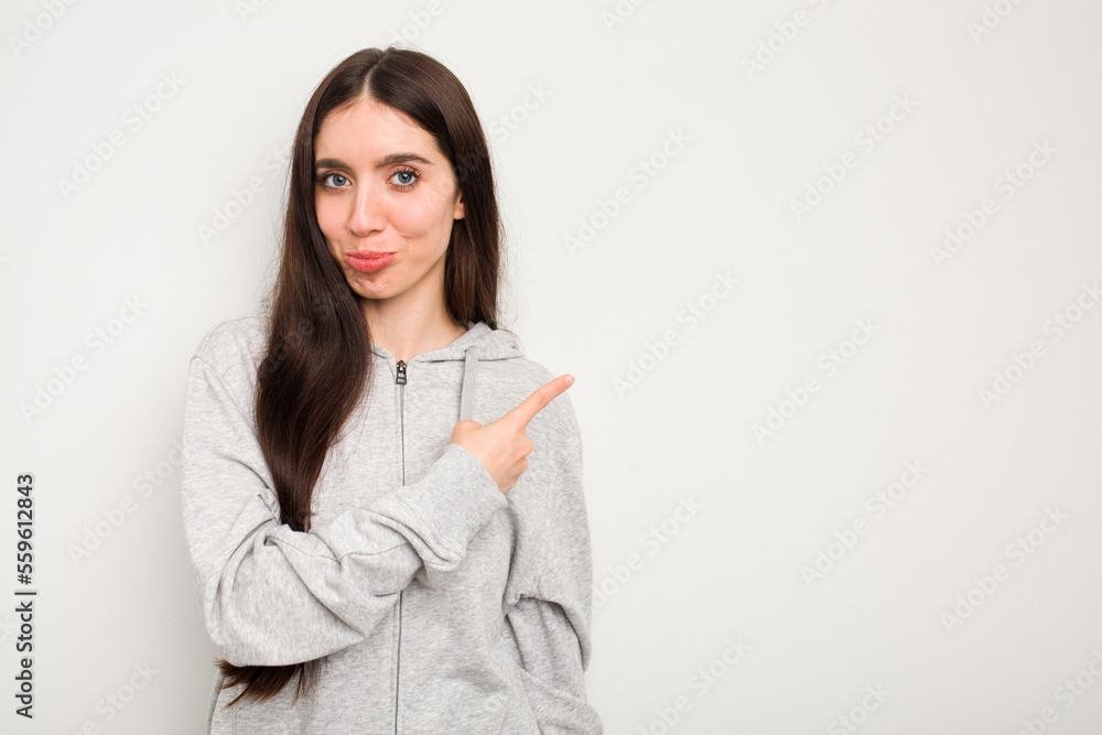 Young caucasian woman isolated on white background smiling and pointing aside, showing something at blank space. Young caucasian woman isolated on white background smiling and pointing aside, showing something at blank space.
