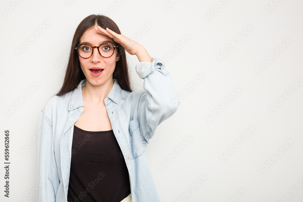 Young caucasian woman isolated on white background shouts loud, keeps eyes opened and hands tense. Young caucasian woman isolated on white background shouts loud, keeps eyes opened and hands tense.