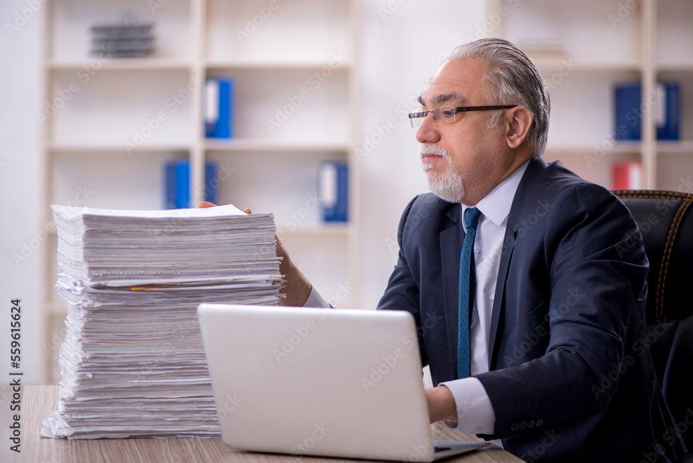 Old male employee and too much work in the office Old male employee and too much work in the office