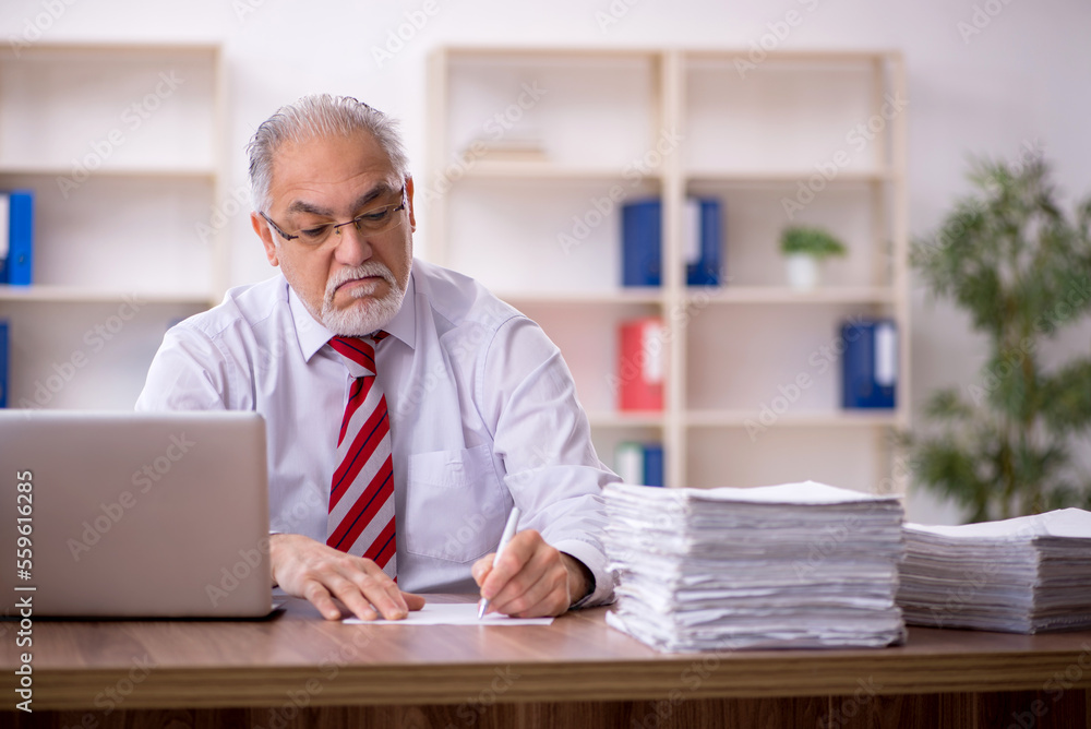 Old male employee and too much work in the office Old male employee and too much work in the office