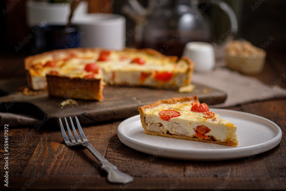 Creamy shortbread pie. Quiche with cherry tomatoes and chicken in the village on a wooden table. Creamy shortbread pie. Quiche with cherry tomatoes and chicken in the village on a wooden table.