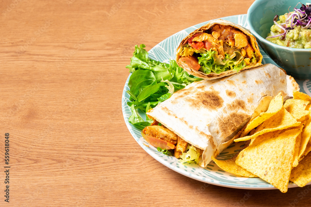 Burritos wraps with beef and vegetables on wooden table. Beef burrito, mexican food. High quality photo
