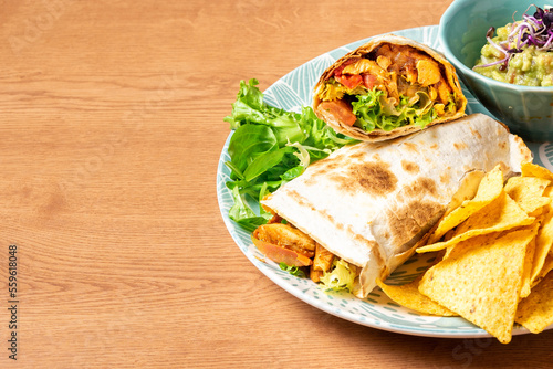 Burritos wraps with beef and vegetables on wooden table. Beef burrito, mexican food. High quality photo