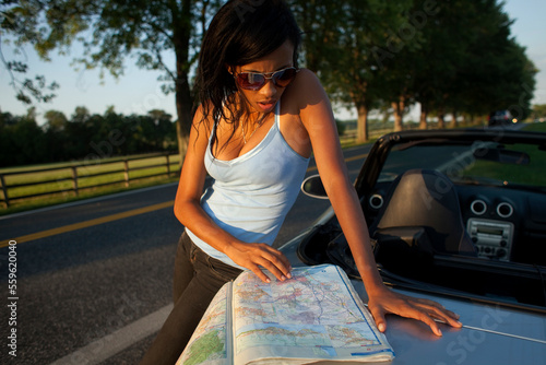 A woman checks her map during a road trip in Butler, Maryland. photo