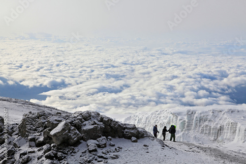 Climbers ascending the crater rim of Mt. Kilimanjaro, up from Stella Point, as seen from the summit area. photo