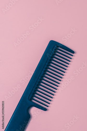 Comb hairdresser on a pink background.