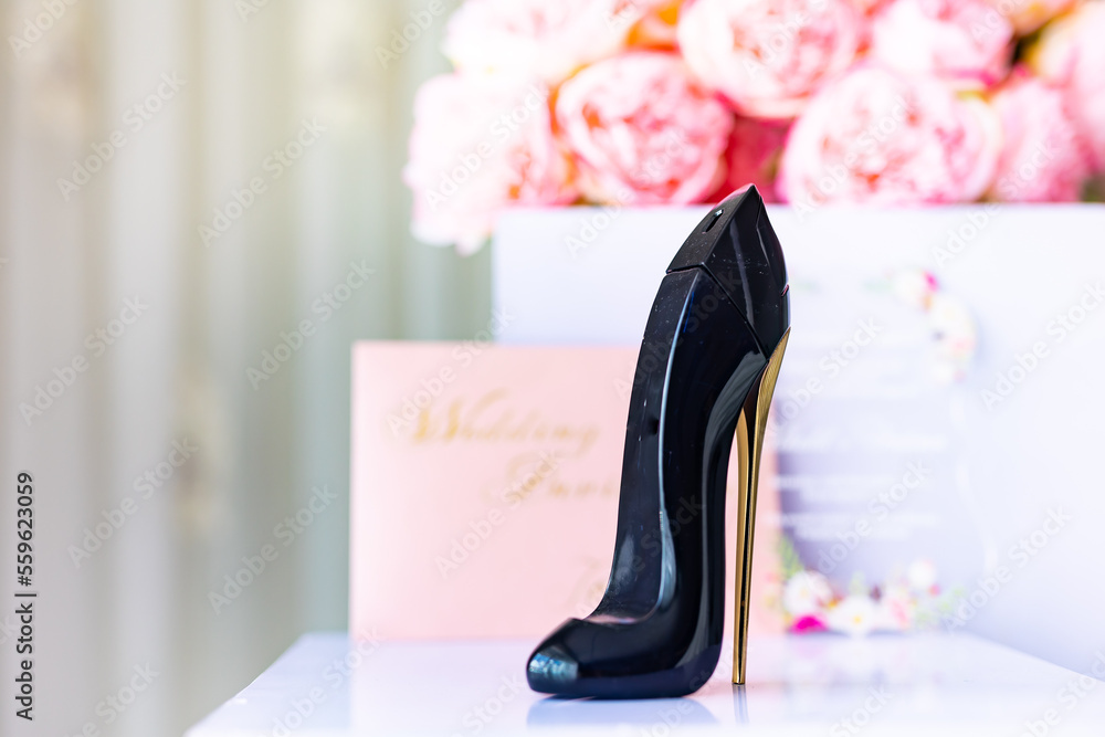 Bride s perfume in a shape of a black shoe close up Stock Photo