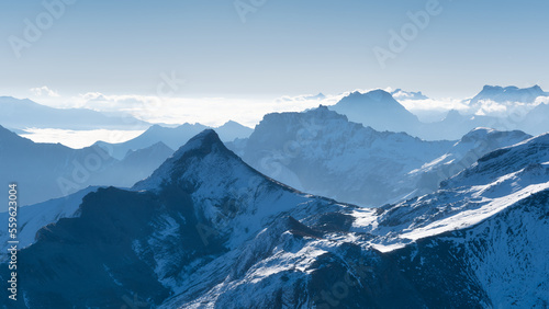 Mountain scenery in the Swiss Alps. Mountains peaks. Natural landscape. Mountain range and clear blue sky. Landscape in the summertime. Large resolution photo.