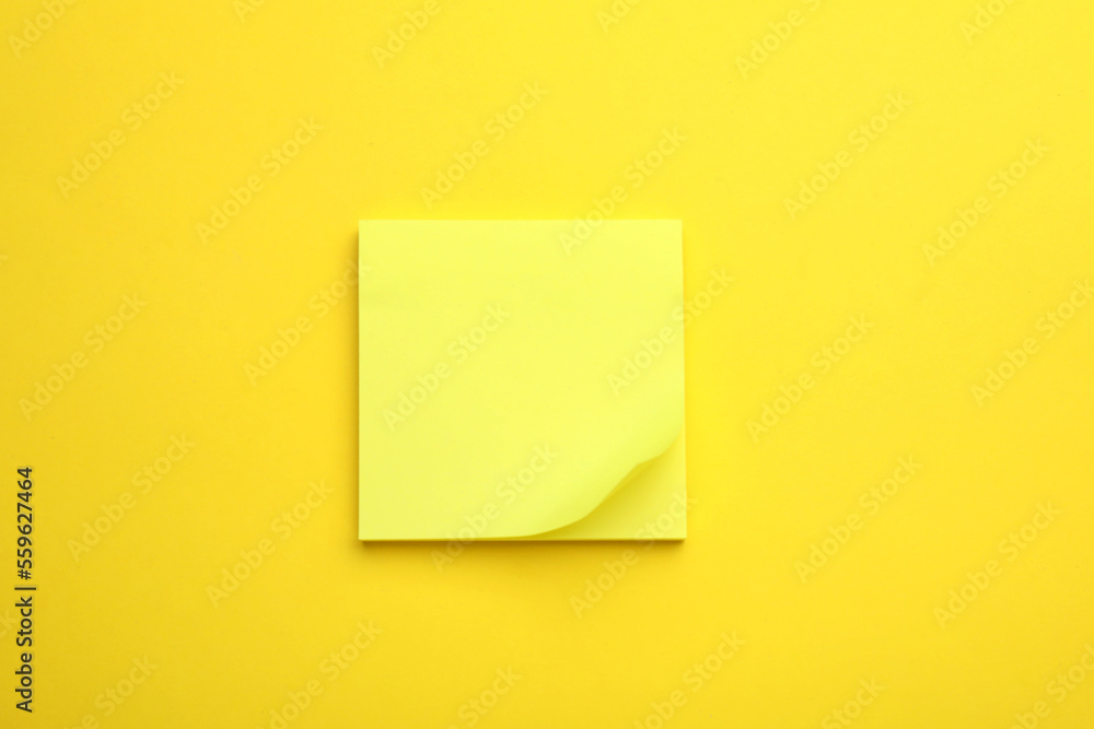 Paper note on yellow background, top view Paper note on yellow background, top view