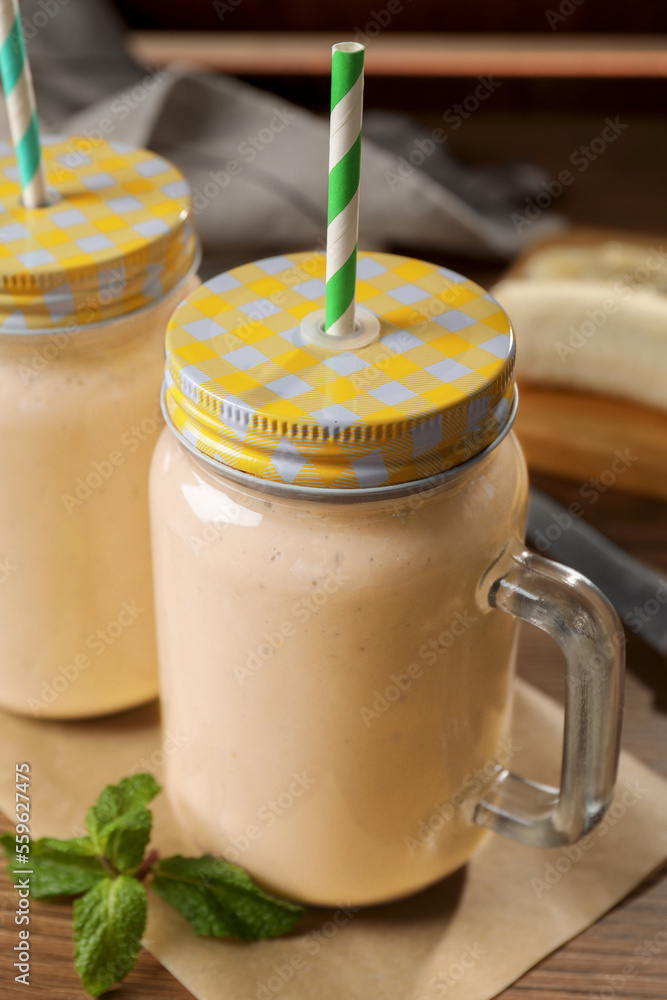 Tasty banana smoothie and mint on wooden table Tasty banana smoothie and mint on wooden table