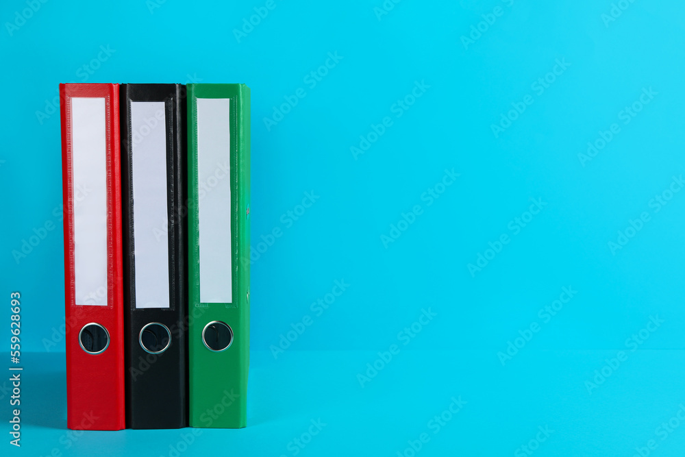 Office folders on light blue background, space for text Office folders on light blue background, space for text