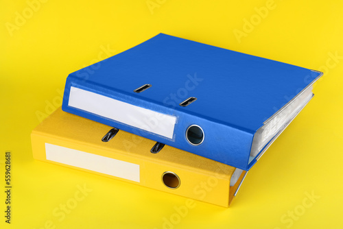 Bright hardcover office folders on yellow background