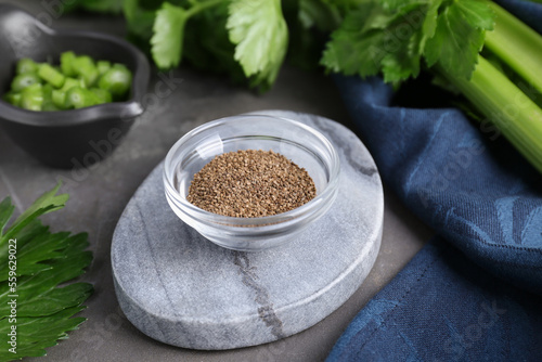 Bowl of celery seeds on grey table  closeup