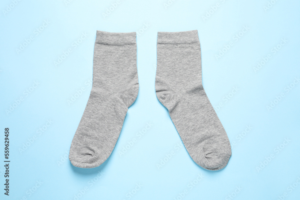 Pair of grey socks on light blue background, flat lay Pair of grey socks on light blue background, flat lay