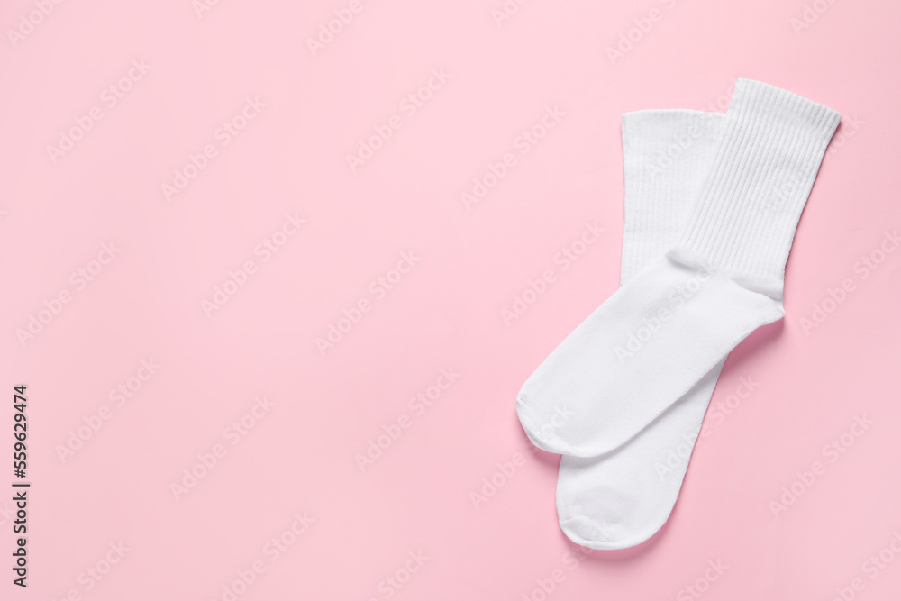 Pair of white socks on pink background, flat lay. Space for text Pair of white socks on pink background, flat lay. Space for text