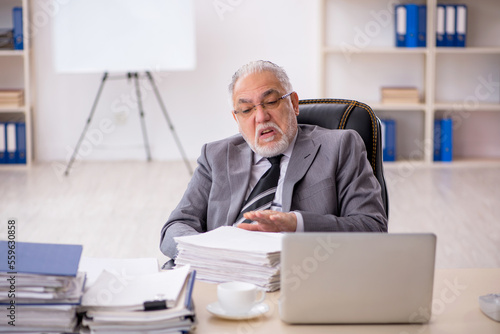 Wallpaper Mural Old male employee working in the office Torontodigital.ca