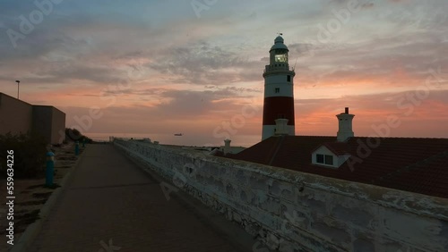 Europa Point Lighthouse with sea in background. Colorful Cloudy Sunrise Sky. Gibraltar, United Kingdom. 4k cinematic