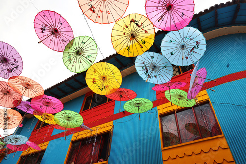 The sky of colourful umbrellas. Street with umbrellas. Beautiful houses of the small town of Raquira. The City of Pots, Colombia.