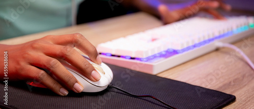 Closeup hands of woman play video game and live streaming online with computer desktop at home, esport or casting game, one person, broadcast and entertainment concept.