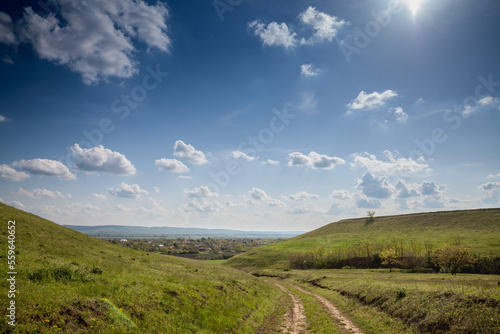 Panorama of Titelski breg, or titel hill, in Vojvodina, Serbia, with a dirtpath countryside road, in an agricultural landscape with blue sky. ....