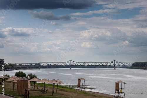 Panorama of the sava river in Sabac, serbia, with a focus on the Zeleznicki most, a steel railway bridge, in front of the city beach. Sabac is a Serbian city in the macva region... photo