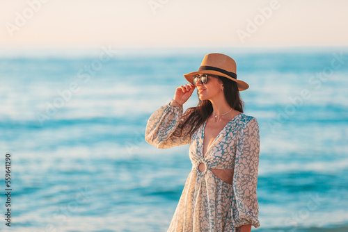 Print op canvas Young happy woman on the beach enjoy her summer vacation