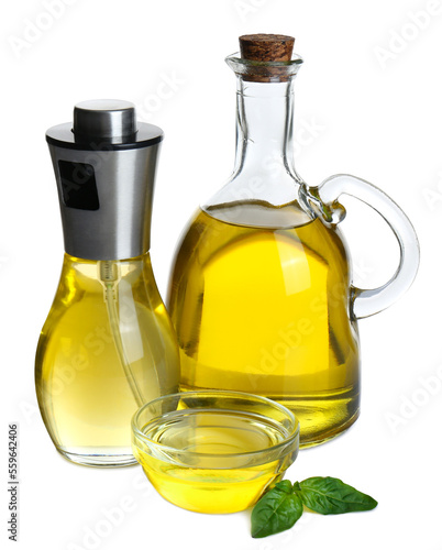 Cooking oil and basil leaves on white background