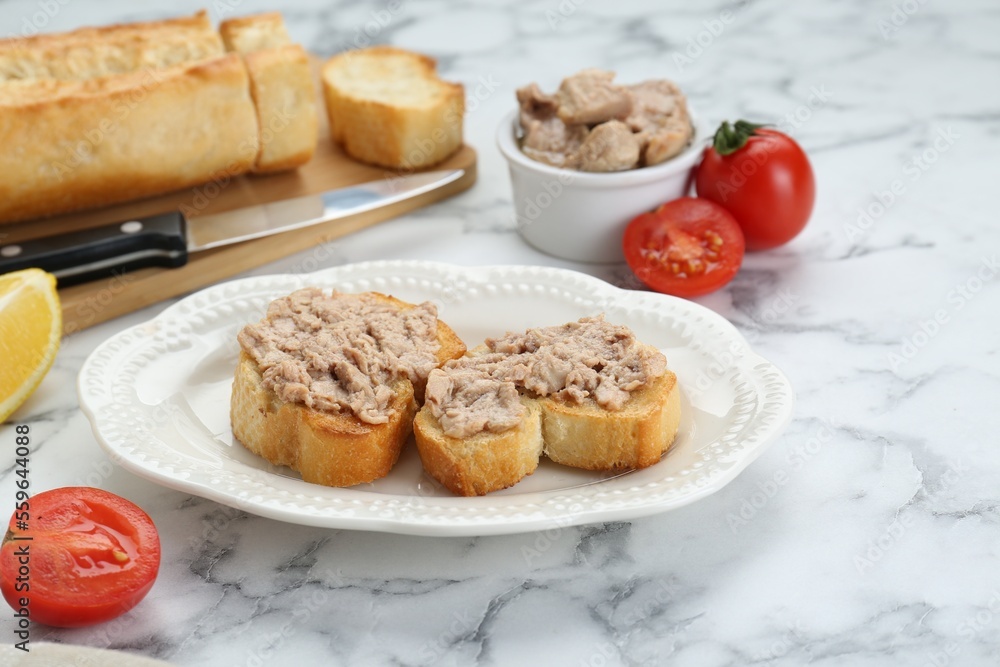 Tasty sandwiches with cod liver on white marble table Tasty sandwiches with cod liver on white marble table