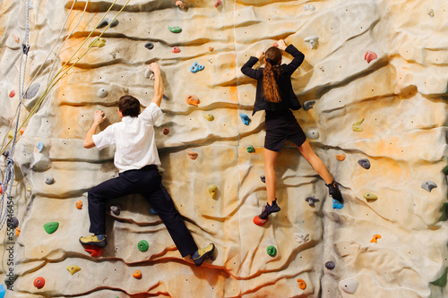 Competition between business partners on man-made cliff in the sport centre