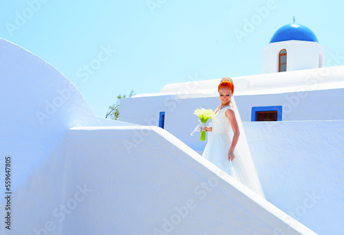 Pretty woman in white wedding dress on Santorini