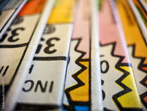 Closeup view of an old comic book collection stacked in a pile creates aolorful background paper texture with abstract shapes photo