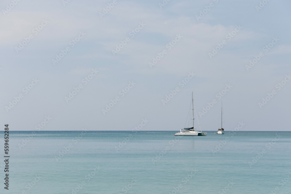 Fototapeta premium Island and boats on blue sky with clouds over the sea, wallpaper, background. 