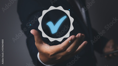 Man holding quality assurance icon or QA and Quality Control or QC.