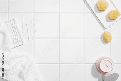 Various bathroom accessories on clean white tile background. top view angle and copy space.