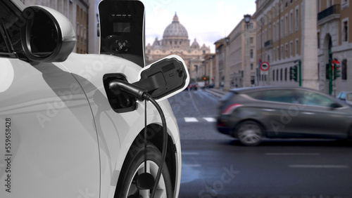 Canvas Print Progressive electric car recharging battery at the charging station in Vatican, historical christian church, city center