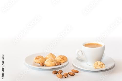 Cup of espresso coffee and almond cookies on white
