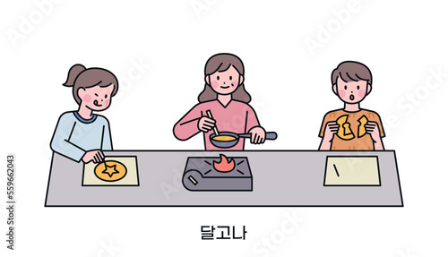 Korean childhood games. Kids playing sugar honeycomb challenge game made with sugar. Korean translation Dalgona- Sugar honeycomb challenge