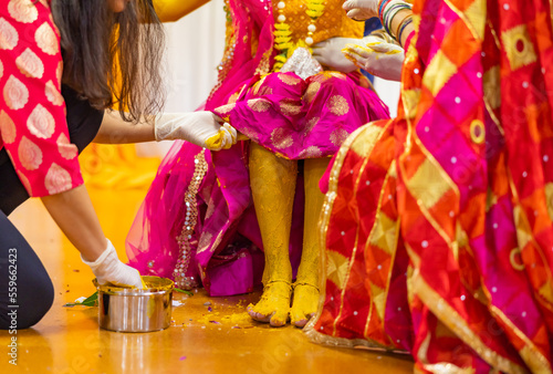 Indian Hindu pre wedding yellow turmeric Haldi ceremony bride's feet close up