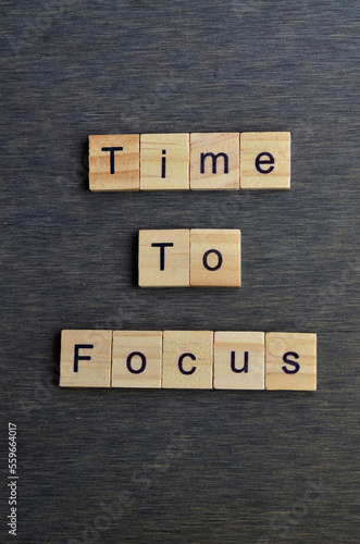 time to focus text on wooden square, inspiration quotes