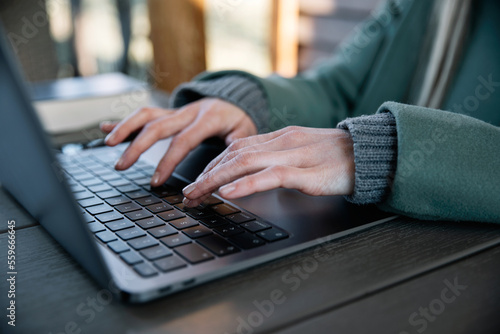 Closeup image of a woman's hands working and typing on laptop keyboard. Bussiness concept.