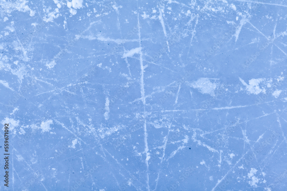 Empty ice rink with skate marks after the session outdoor. skating ice rink texture covered with snow in daylight. Close up of blue ice rink floor, copy space Empty ice rink with skate marks after the session outdoor. skating ice rink texture covered with snow in daylight. Close up of blue ice rink floor, copy space