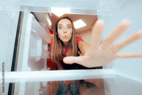 фотографія Hungry Woman Reaching for Something to Eat in the Fridge