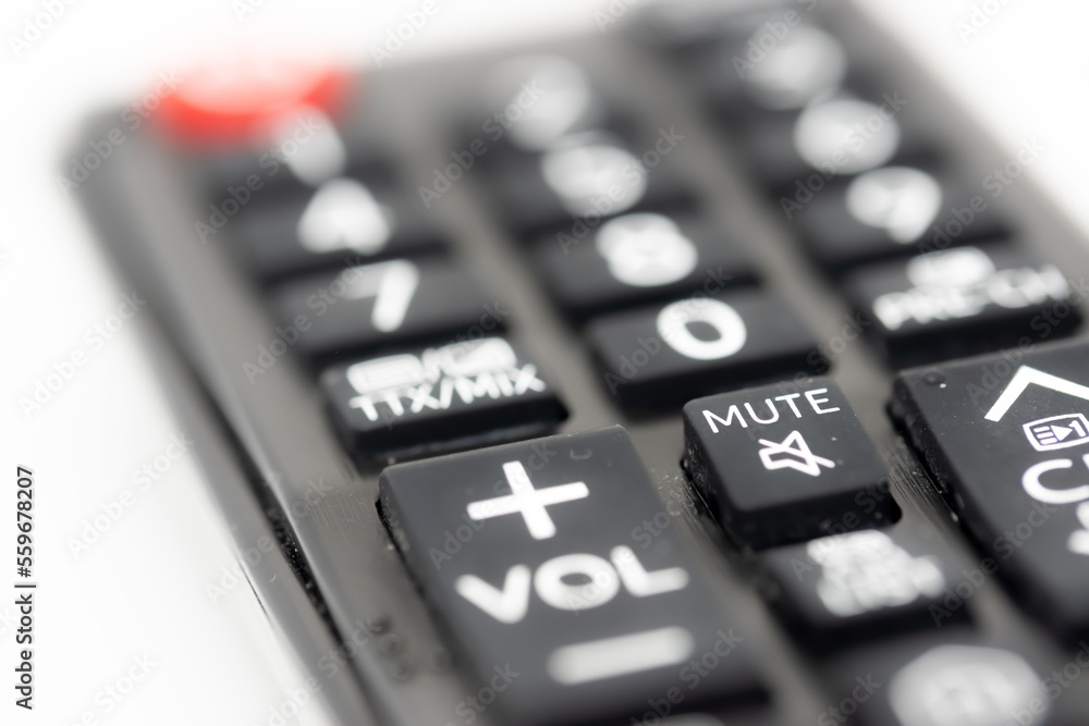 TV remote control with focus on volume and mute buttons, concept of deafness TV remote control with focus on volume and mute buttons, concept of deafness