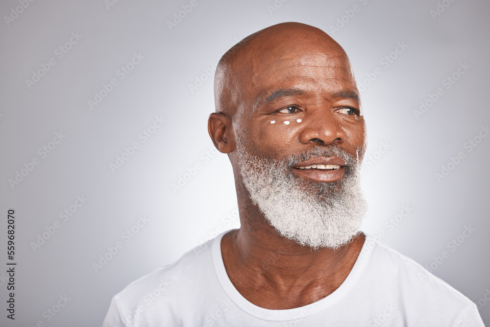 Black man, beauty and facial cream for skincare of senior in studio for self care with dermatology and cosmetic product on skin. Face of happy male with lotion for glow, health and wellness on grey Black man, beauty and facial cream for skincare of senior in studio for self care with dermatology and cosmetic product on skin. Face of happy male with lotion for glow, health and wellness on grey