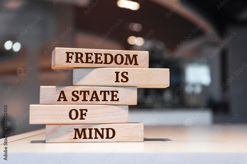 Wooden blocks with words 'Freedom Is a State of Mind'.
