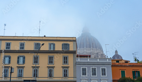 Obraz na płótnie Dome of the church, basilica in the mist. Buildings, tenements, windows, shutters, blue sky. w salonie
