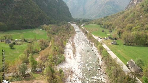 Aerial View Of Maggia River Flowing Down On the Village Of Bignasco, Vallemaggia, Canton of Ticino, Switzerland.  photo