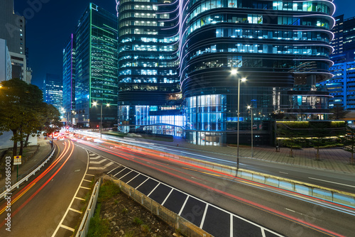 Night scenery of modern office building and traffic in downtown district of Hong Kong city